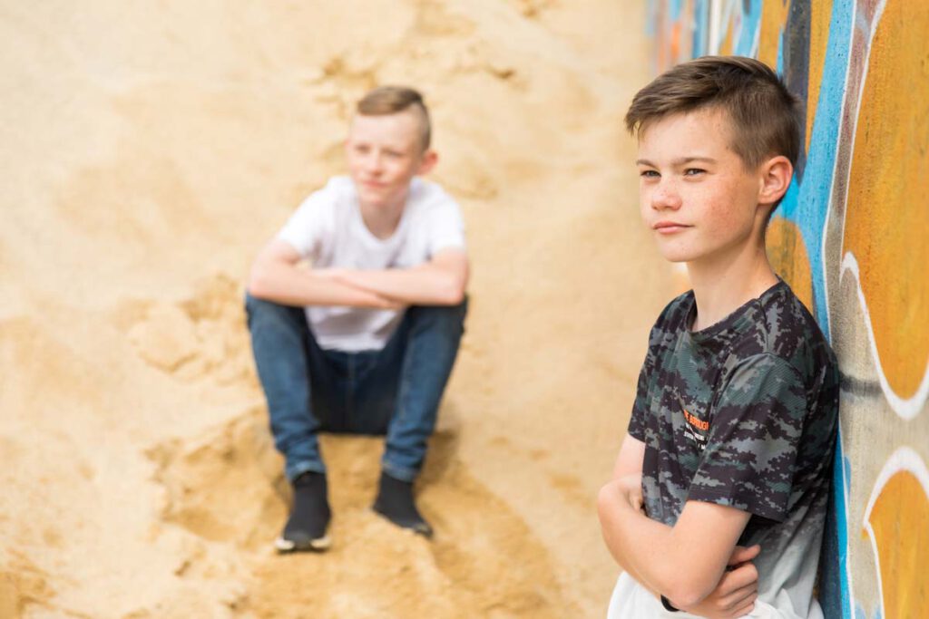Jan Windisch, Fotograf und Hochzeitsfotograf aus Dresden, Prina, Görlitz, Großenhain und Leipzig, hat hier zwei Kinder fotografiert. Der eine sitz im Hintergrund auf dem Boden. Der zweite steht im Vordergrund und lehnt mit verschränkten Armen an der Wand im rechten Bild.